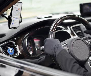 Driver using taxi app in car
